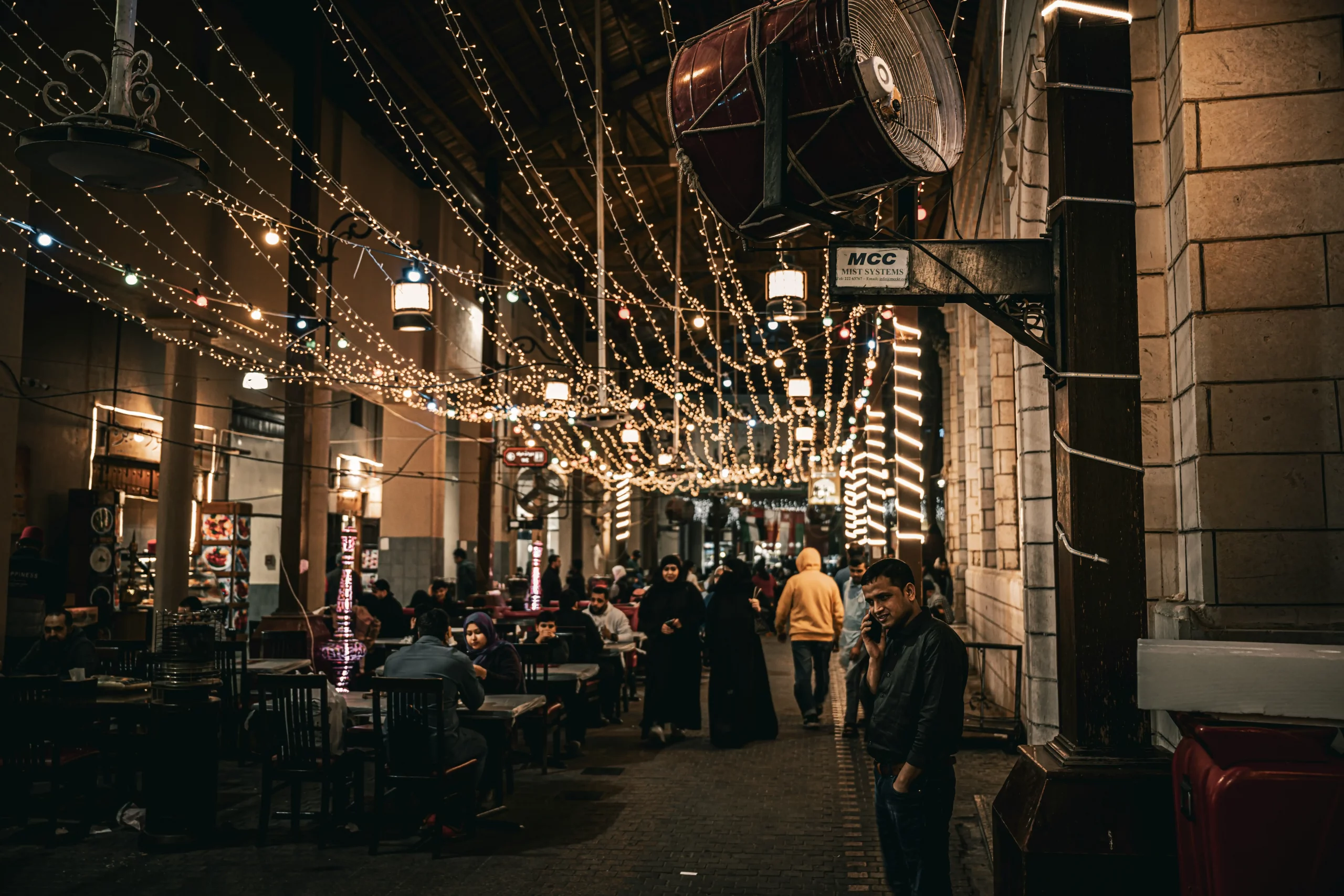 elegant group of family members in winter formalwear stepping out of a luxury stretch limo near a downtown Seattle holiday event, warm string lights overhead