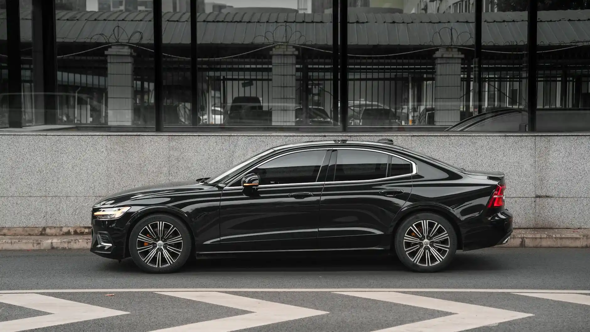 corporate black sedan and luxury SUV outside a glass office tower in downtown Seattle, professionally dressed chauffeur, early morning city skyline, executives entering vehicle