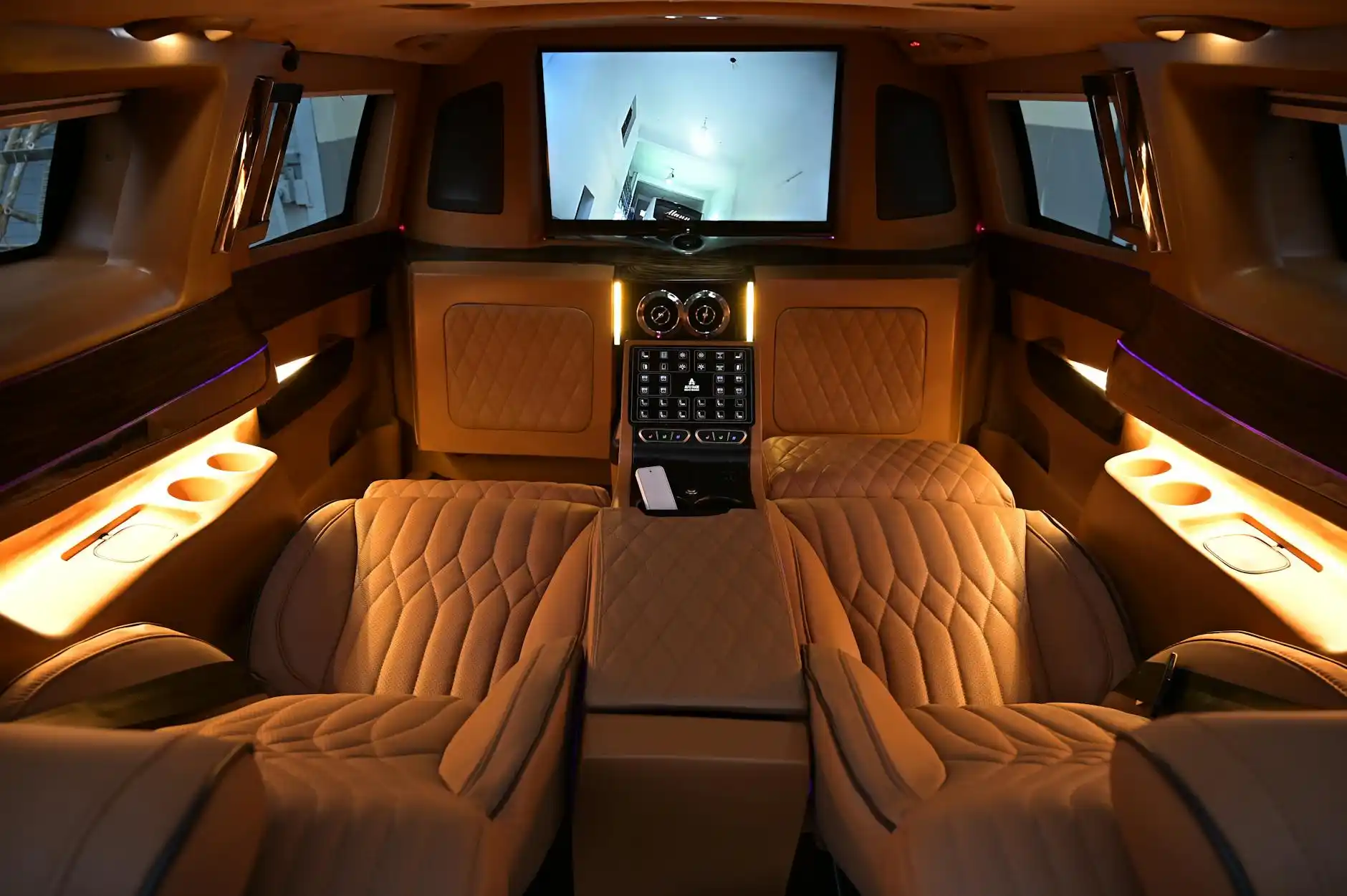 upscale limousine interior with soft ambient lighting, quilted leather seating, bottled water, city skyline reflections through tinted windows, elegant and modern atmosphere
