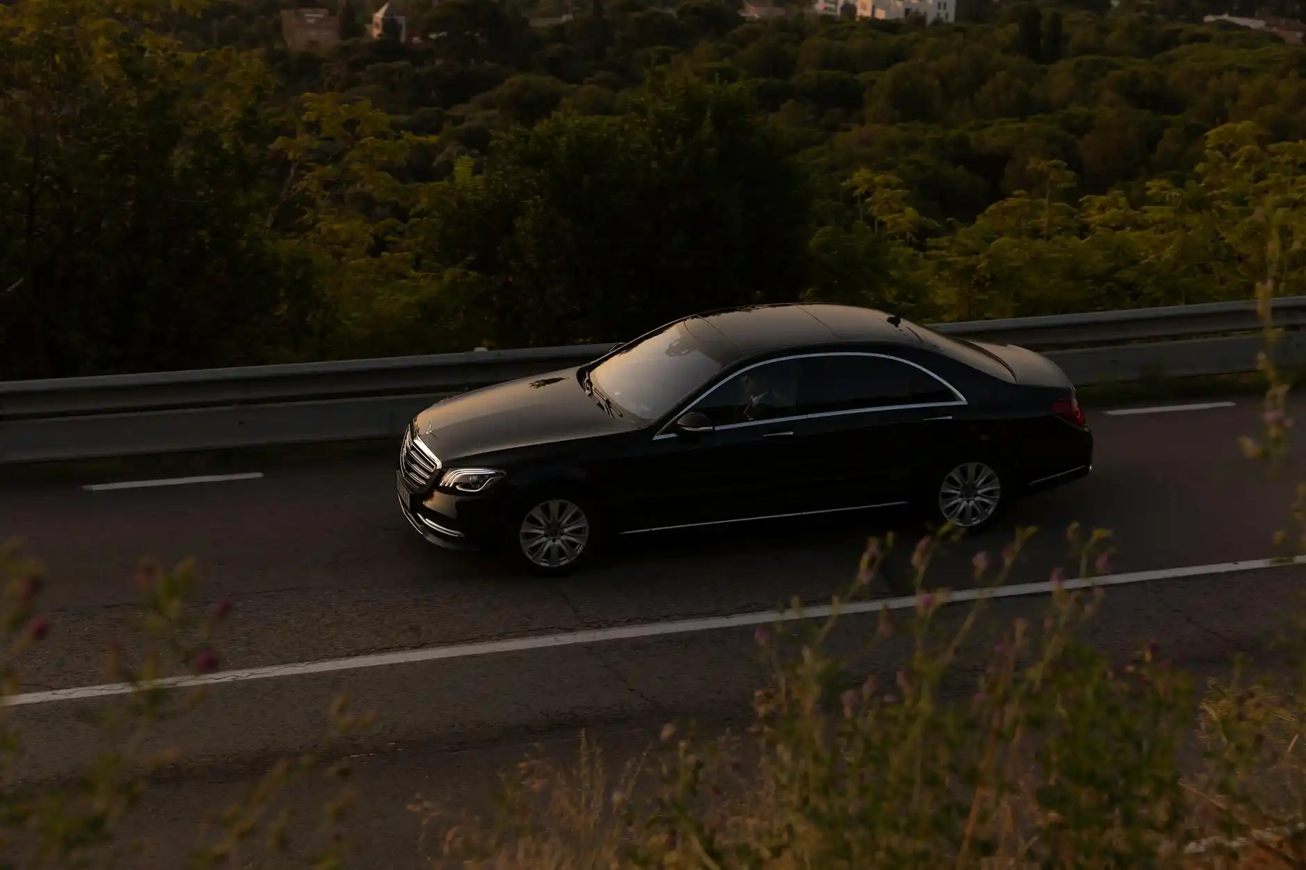 elegant Seattle evening scene with a black luxury sedan parked near a fine dining restaurant in Belltown, city lights, valet stand, and dressed-up couple approaching
