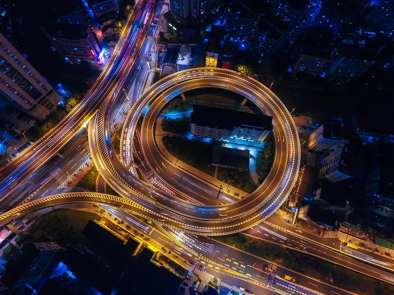 aerial-style urban traffic scene in Seattle with congested downtown streets and one polished black sedan moving through a business district near South Lake Union